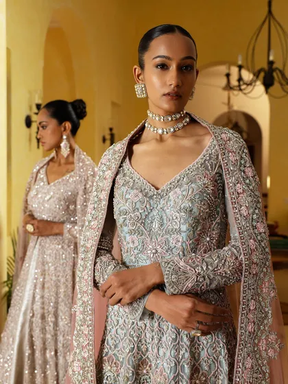 A detailed shot focusing on the craftsmanship of the pastel blue embroidered gown. The clean neckline is perfect for showcasing a statement choker, a key element of my jewelry styling.