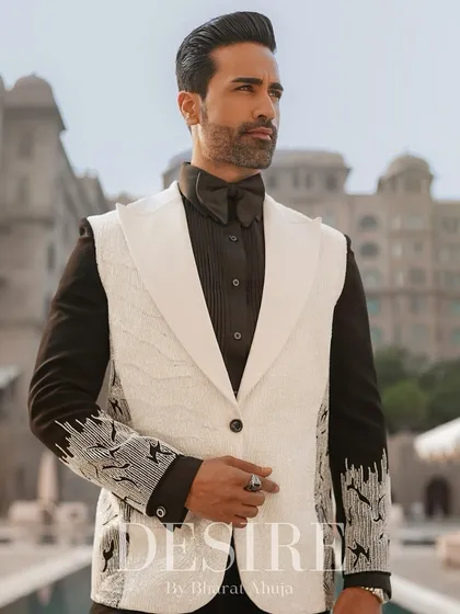 This image captures the sophistication of the sleeveless white blazer. The combination of the textured white vest, black shirt, and bow tie is pure elegance.