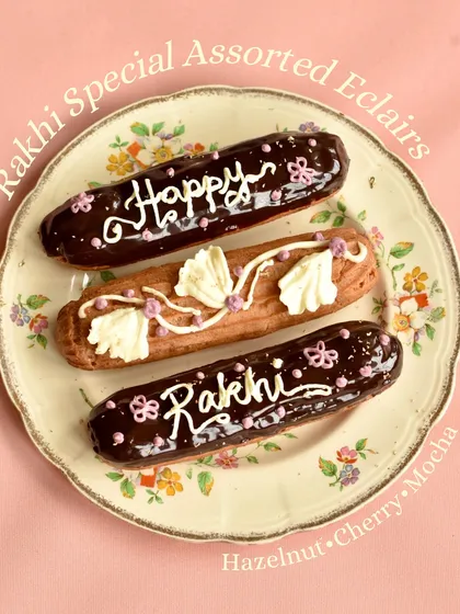 Our Rakhi Special Assorted Eclairs, with delicious fillings like Hazelnut, Cherry, and Mocha, and decorated to say "Happy Rakhi."