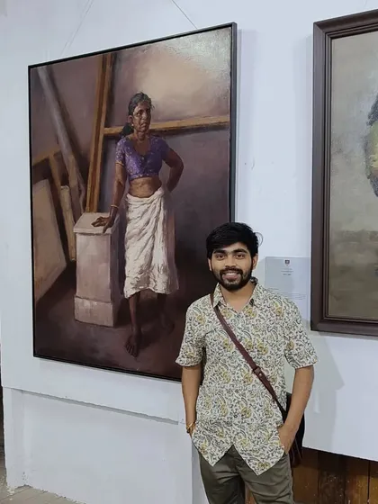 A solo shot of me with my painting "Amma" at the exhibition.