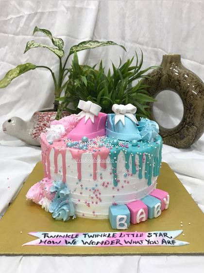 A full shot of the pink and blue baby shower cake, perfect for celebrating the little one on the way.