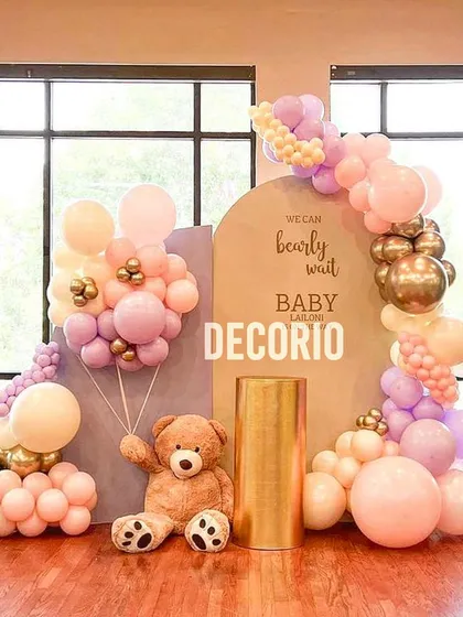 For this "We Can Bearly Wait" baby shower, I used a warm palette of pinks and golds against a neutral backdrop. The teddy bear holding a balloon bunch adds a touch of whimsy to this elegant setup.