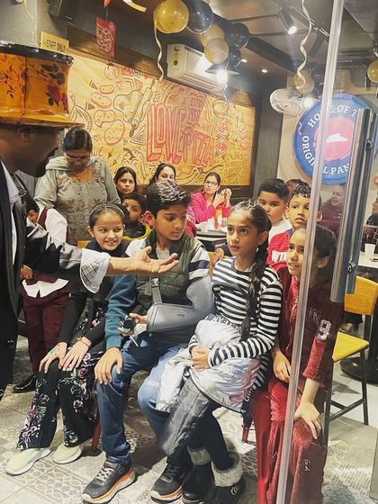 Leaning in to share a magical secret with the kids. These interactive moments are what make the show so memorable for them.