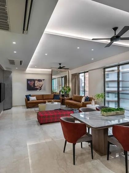 A sunlit sanctuary. This 3-bedroom Mumbai home was designed to maximize natural light, with an open layout and strategically placed mirrors that make the entire living and dining area feel radiant and expansive.