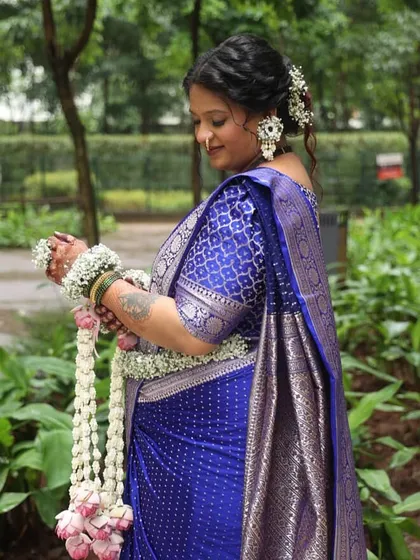 A side profile showing the floral hair accessories and large, statement earrings from a baby shower set. I ensure every piece coordinates perfectly.