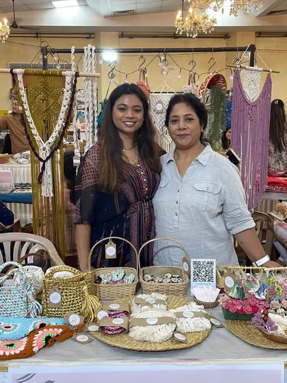 Posing proudly behind the table full of my creations. You can see a variety of wall hangings and bags in the background.