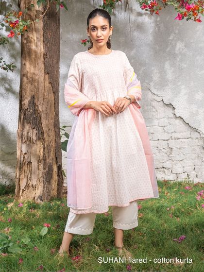 Our Suhani flared cotton kurta from the appliqué collection, styled with a light dupatta. The combination of block prints and appliqué creates a textured, layered look that is both traditional and contemporary.