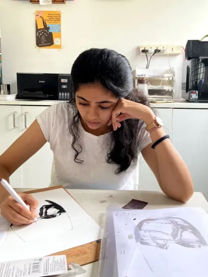 This student is focused on her charcoal drawing, learning how to create realistic textures and forms.