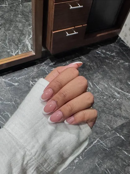 Another shot of our flawless classic French manicure, showcasing the clean lines and natural-looking finish.
