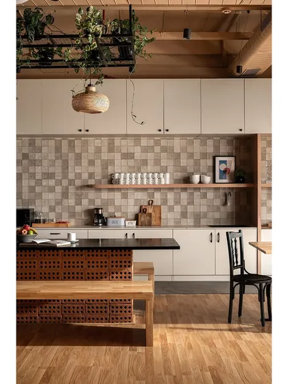 I believe even functional spaces like a pantry should feel uplifting. Here, we used simple materials like hollow bricks for the island base, beige tiles, and plenty of plants to create a serene and inviting kitchen area for employees.