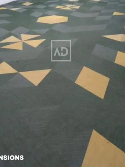 A custom carpet tile installation with a playful geometric pattern in green and yellow. This is a great choice for creative offices, schools, or children's areas.