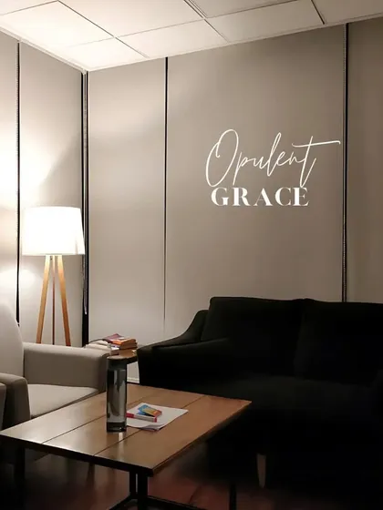 A simple yet graceful waiting area, designed with comfortable seating and soft, warm lighting to create a welcoming first impression.