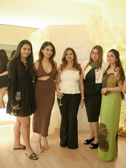 Our members dressed up and brought the best energy to our first anniversary party. Here's a group enjoying the evening against our celebration backdrop.