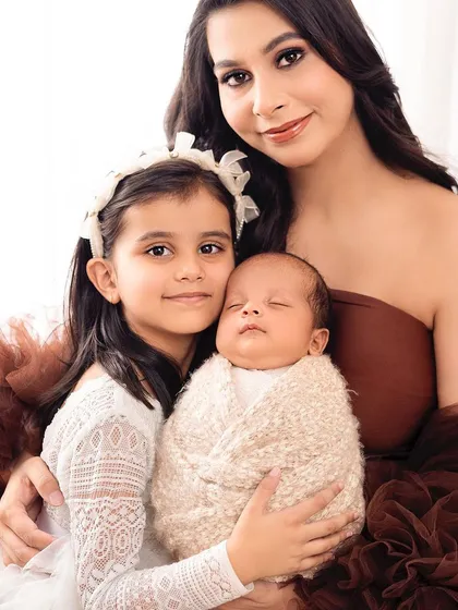 A mother, her firstborn, and her newborn, all together. This portrait beautifully captures the love that expands with each new child.