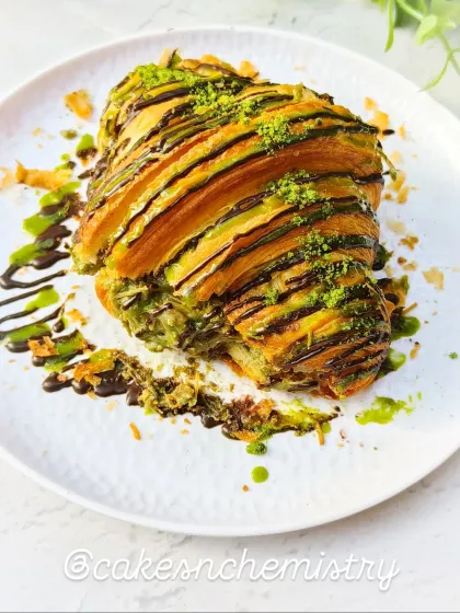 This is my Pistachio Croissant, a sophisticated treat for those who love nutty flavours. It's filled with a rich pistachio cream and finished with a drizzle of chocolate and a sprinkle of pistachio dust.
