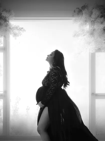 A stunning black and white silhouette against a bright window. The lace gown and the dramatic lighting create a breathtaking and artistic portrait.