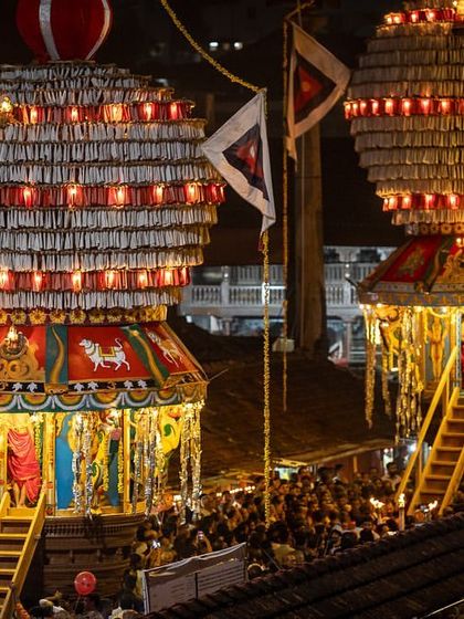 The Laksha Deepotsava (festival of a lakh lamps) at the Udupi Krishna Mutta. The two main temple chariots are beautifully illuminated, surrounded by a crowd of devotees.