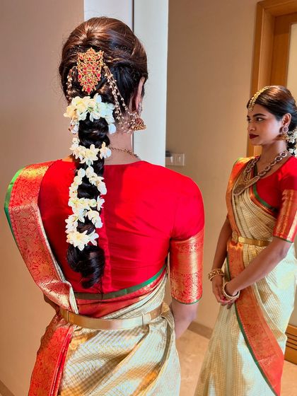 A closer look at the traditional braid with jasmine and temple jewellery, highlighting the intricate details that make this style so special for a muhurtham.
