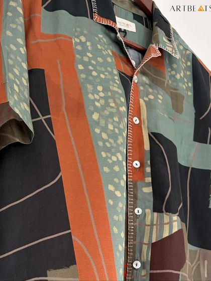 A detailed close-up of the Earthlines shirt fabric. The combination of block-like shapes and dotted patterns in earthy tones creates a visually rich and artistic design.