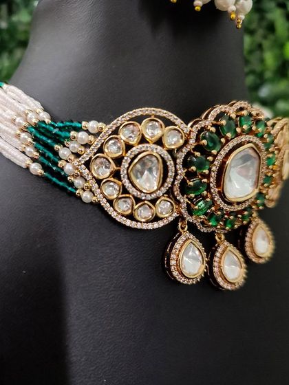 A close-up of a beautiful green and white kundan choker.