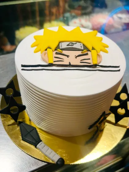 A cool Naruto-themed cake for an anime fan, featuring the iconic character peeking over the top.