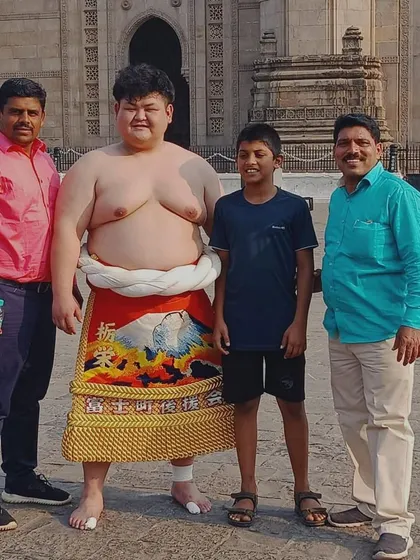 Wrestling connects people across cultures. Here I am with one of our students meeting a Japanese sumo wrestler at the Gateway of India during a cultural exchange.