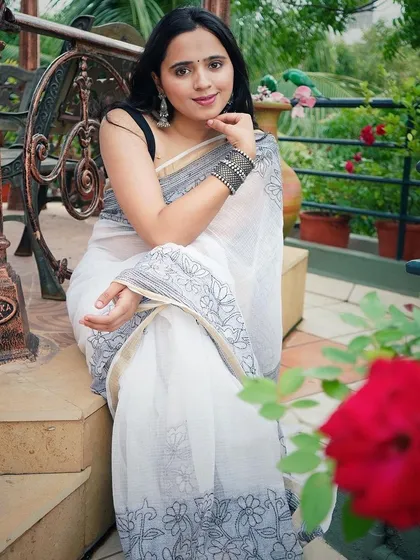 Another beautiful shot of the model in the Anorah saree, showcasing its elegance in a garden setting.