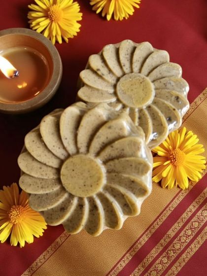 The warm glow of a diya next to my Abhyangasnan Ubtan Soap. This bar is perfect for infusing your gifting hampers with tradition and wellness.