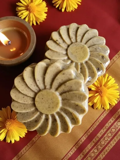 The warm glow of a diya next to my Abhyangasnan Ubtan Soap. This bar is perfect for infusing your gifting hampers with tradition and wellness.