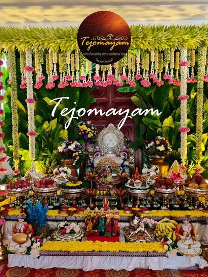 A half-saree ceremony setup with a backdrop of banana leaves and hanging floral garlands, complemented by a detailed arrangement of offering plates.