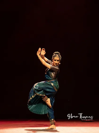 The dramatic lighting at the Nishagandhi Auditorium helped create a powerful atmosphere. Here, a simple pose is amplified by the stark contrast of light and shadow.