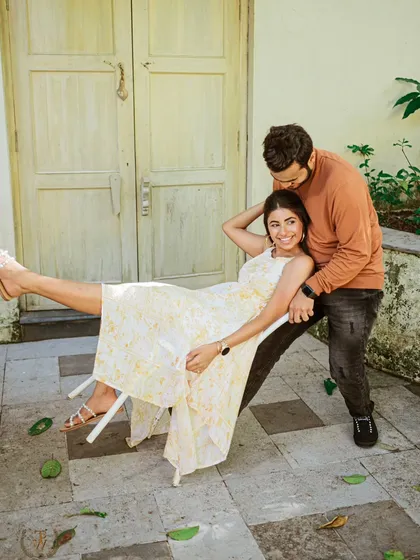 A quirky and fun moment with a chair used as a prop in a beautiful Goan villa. This creative couple photo shows that pre-wedding shoots can be full of laughter and spontaneity.