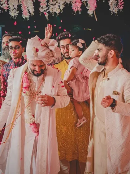 The couple surrounded by their cheering friends and family after the wedding ceremony. It's all about celebrating together.