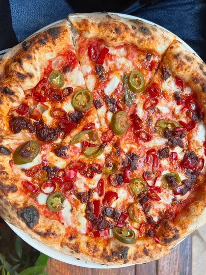 Friday calls for a whole pie! This spicy number with jalapeños and red chili is the perfect way to kick off the weekend.