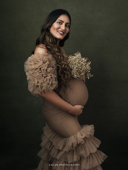 Holding a simple bouquet of baby's breath, this portrait adds a delicate touch to the dramatic gown.