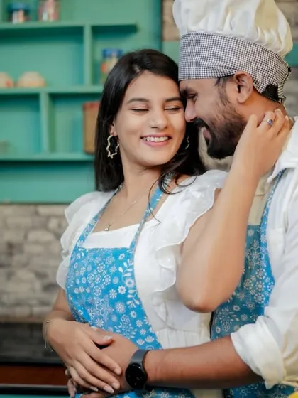 Love is cooking up something beautiful! This couple shares a laugh in a quirky kitchen setting, a perfect example of a themed pre-wedding shoot that reflects shared interests and creates fun, natural interactions.