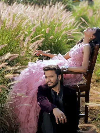 A creative and candid portrait of the couple in a field, showcasing a relaxed and natural interaction.