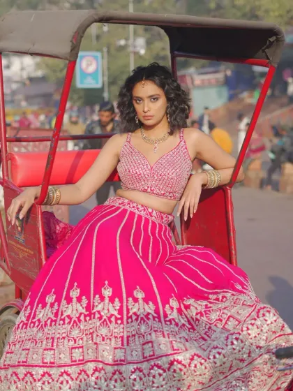 This look is for the bride who wants to make a statement. A vibrant pink lehenga with detailed silver embroidery, captured in the heart of the city. It’s proof that you can be traditional and a total trendsetter at the same time.