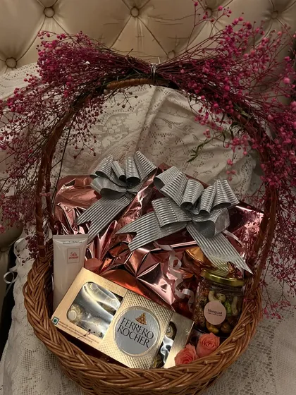 A top-down view of the birthday basket, showing the generous silver bows on the gifts and the rich texture of the wicker. It’s a perfect example of a thoughtful, curated gift.