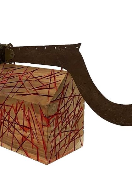 'Objects of vanishing life', a sculpture by Unnikrishnan C. The piece combines wood and a found object (a sickle) to comment on changing ways of life.