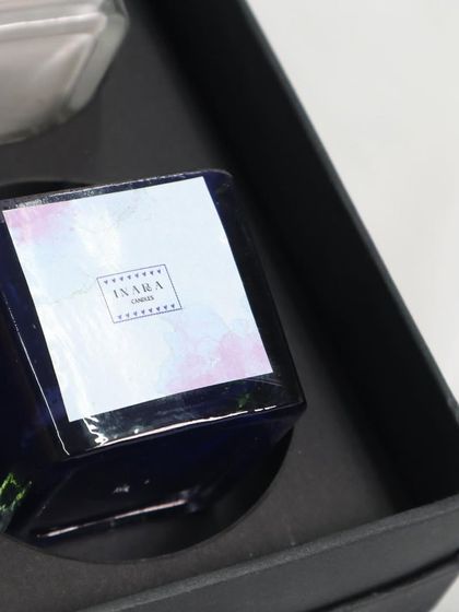 We pay attention to every detail. This dark blue candle with a custom label sits perfectly in its designated slot within our multi-candle gift box.