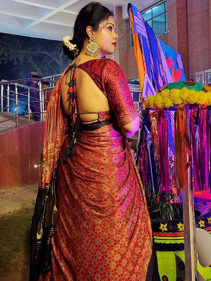 The back of this lehenga blouse features a stunning, deep-cut design with tassels, adding a touch of modern allure to a traditional Navratri outfit.
