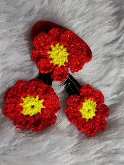 A set of three fiery red floral tic-tac clips. The bright red petals with a sunny yellow center make these clips pop.