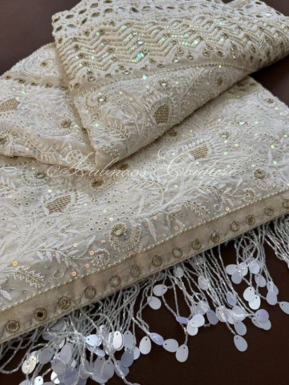 A detail shot of the pallu's corner, highlighting the hand-sewn tassels made of sequins.