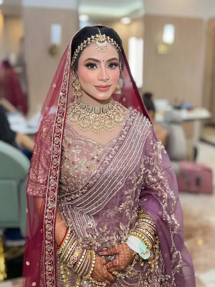 The makeup is soft and radiant, letting the beautiful color of her outfit shine.