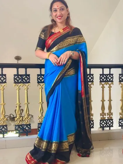 A client looking stunning in a blue and black pure Mysore crepe saree with a Ganga Jamuna border.