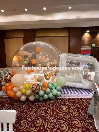Our Bubble House decorated with a jungle-themed balloon garland, showing how it can be customized to fit any party's decor.
