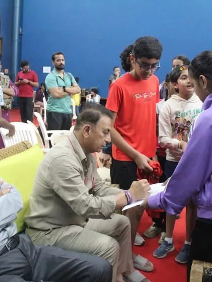 Young fans eagerly line up for an autograph from chief guest Sunil Gavaskar. We manage guest appearances and interactions to create a memorable experience for all attendees.