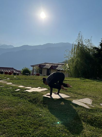 Working on my Bakasana (Crow Pose) with the Himalayan mountains as my witness. The focus required for arm balances helps to quiet the mind and bring you fully into the present moment.