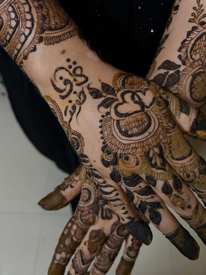 A close-up of a custom name in Arabic script, integrated into a bold floral design. This is a perfect example of combining personalization with the Indo-Arabic style.